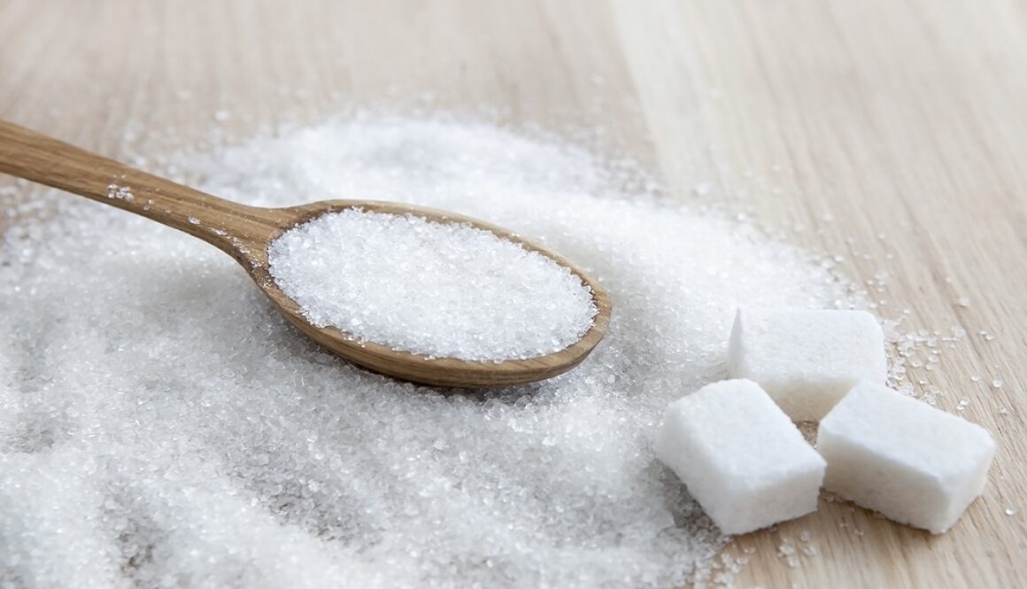 Sugar on wooden table. Selective focus